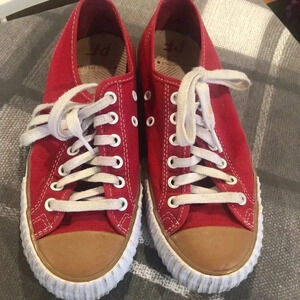 PF Flyer red sneaker with white trim and tan front.